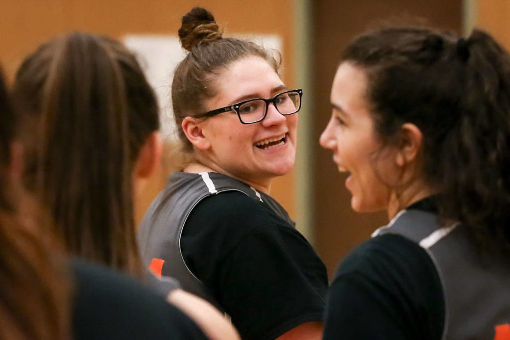 Granite Falls’ Sadie Hutchinson (center) shares a laugh with teammates MacKenzie Petit (left) and Jasmin Myers (right) during practice on Dec. 19, 2017, at Granite Falls High School. (Kevin Clark / The Herald)
