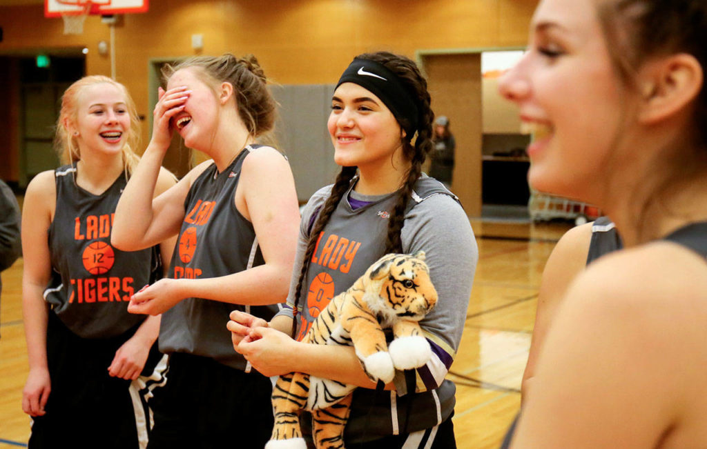 Granite Falls’ Sarah Banks (left), Rylee Downs (second from left), Nicole Jocobi (center) and MacKenzie Petit (right) share a laugh after practice on Dec. 19, 2017, at Granite Falls High School. (Kevin Clark / The Herald)
