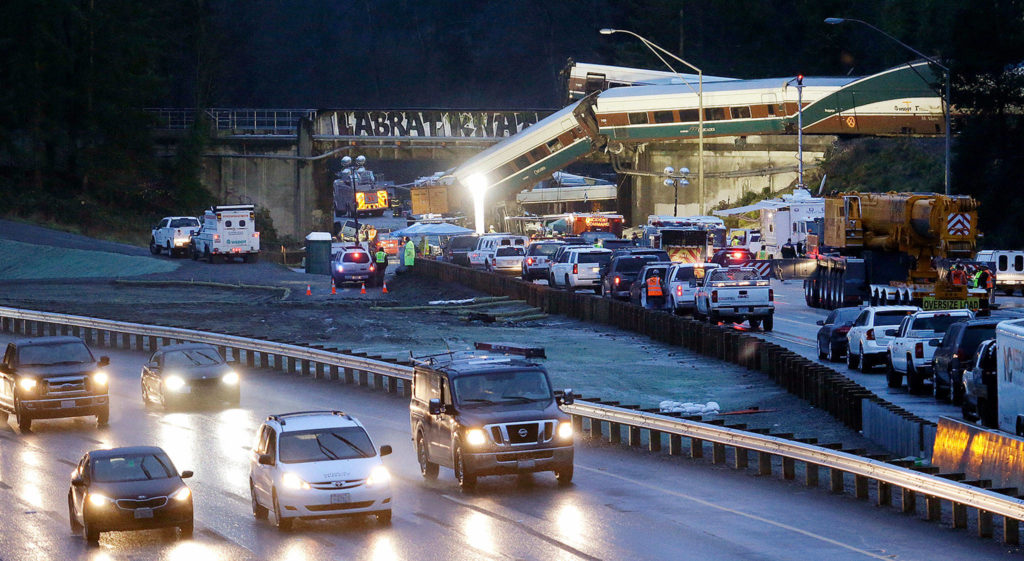 Traffic moves along northbound I-5 (left) as southbound lanes are filled with emergency vehicles near the scene of an Amtrak train crash Monday near DuPont. (AP Photo/Elaine Thompson)
