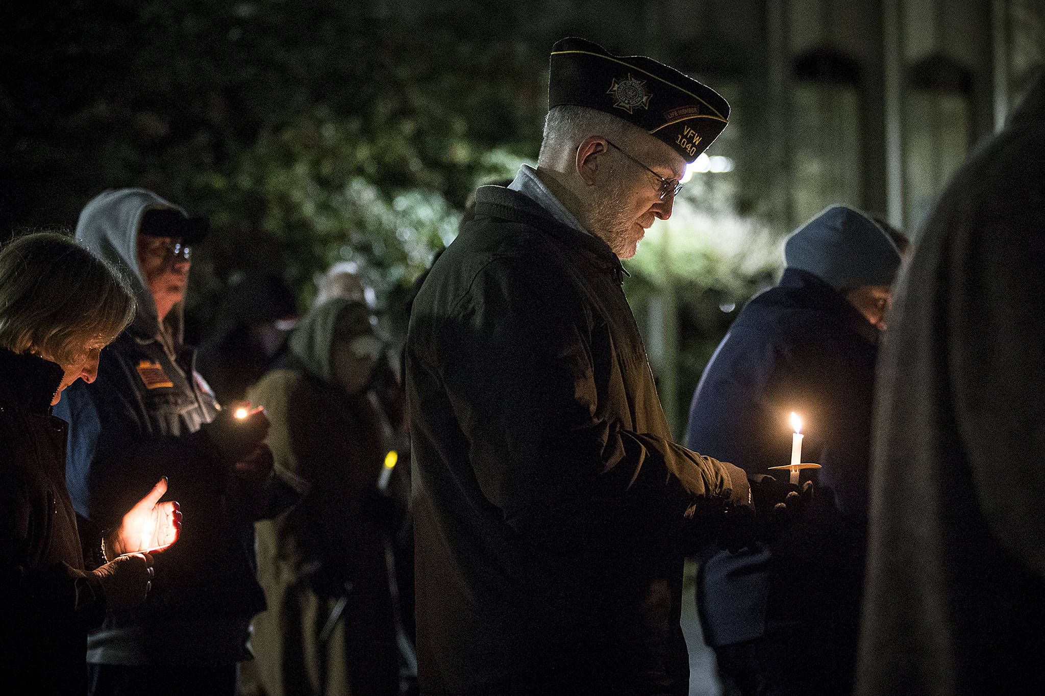 Army veteran Brian Seguin, of Everett, holds a candle at a vigil outside the Snohomish County Courthouse in Everett on Thursday in remembrance of deaths this year within the area’s homeless population. The annual vigil had a special emphasis on homeless veterans and the difficulties they face. (Ian Terry / The Herald)