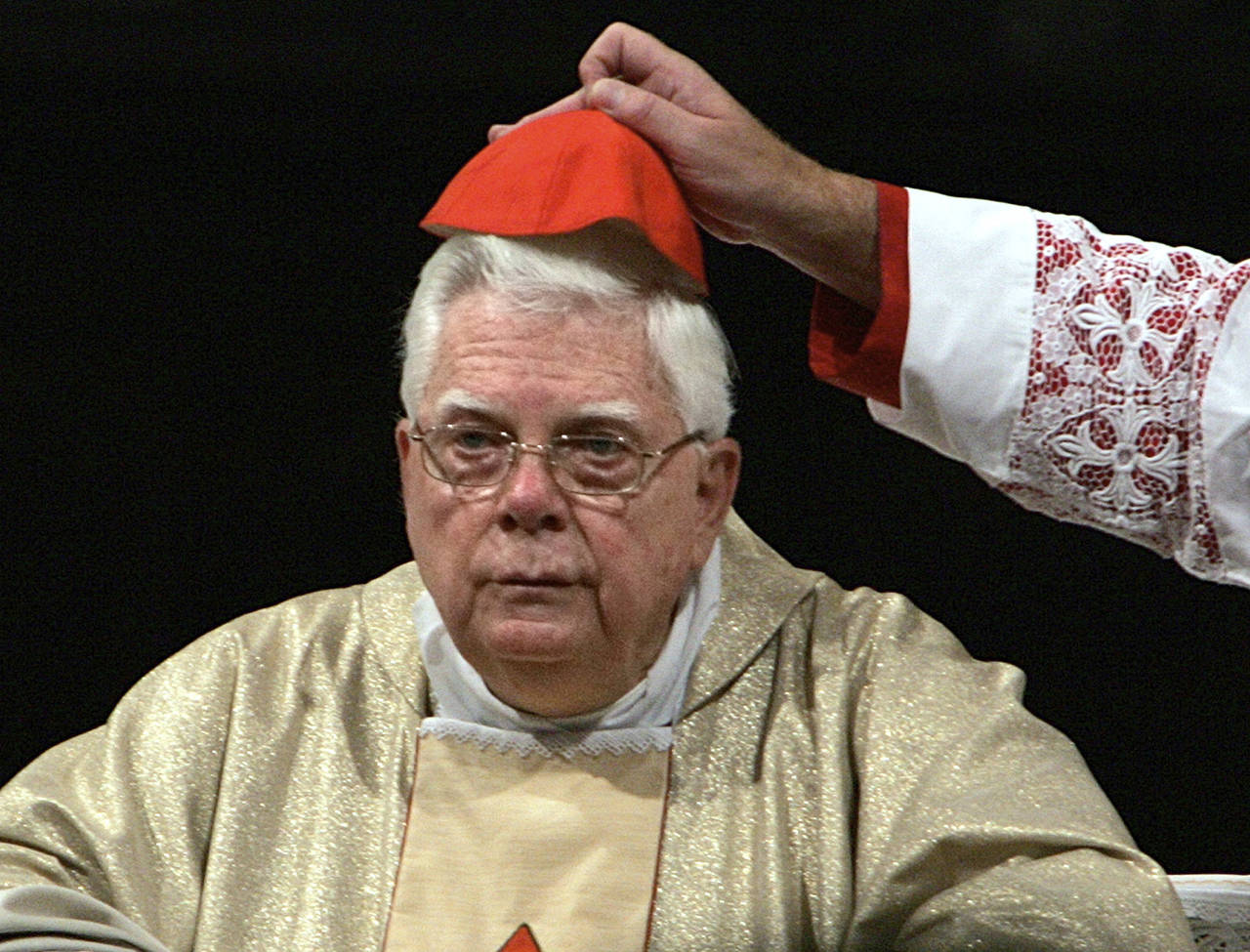 In this 2004 photo, Cardinal Bernard Law has his skull cap adjusted during the ceremony for Our Lady of the Snows, in St. Mary Major’s Basilica in Rome, Italy. (AP Photo/Domenico Stinellis, File)