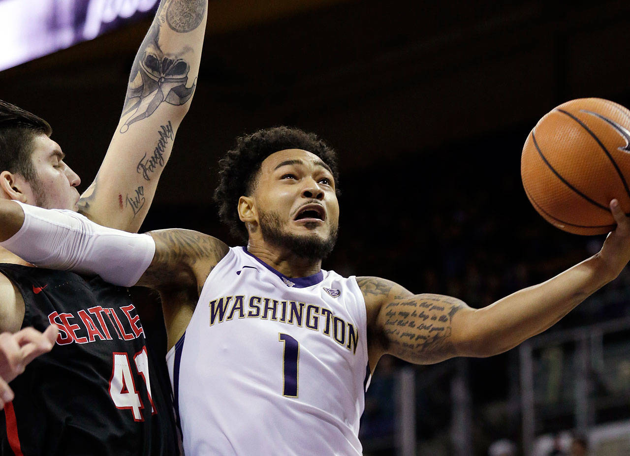 Washington’s David Crisp (1) drives past Seattle’s Aaron Menzies during a game Nov. 24, 2017, in Seattle. (AP Photo/Elaine Thompson)
