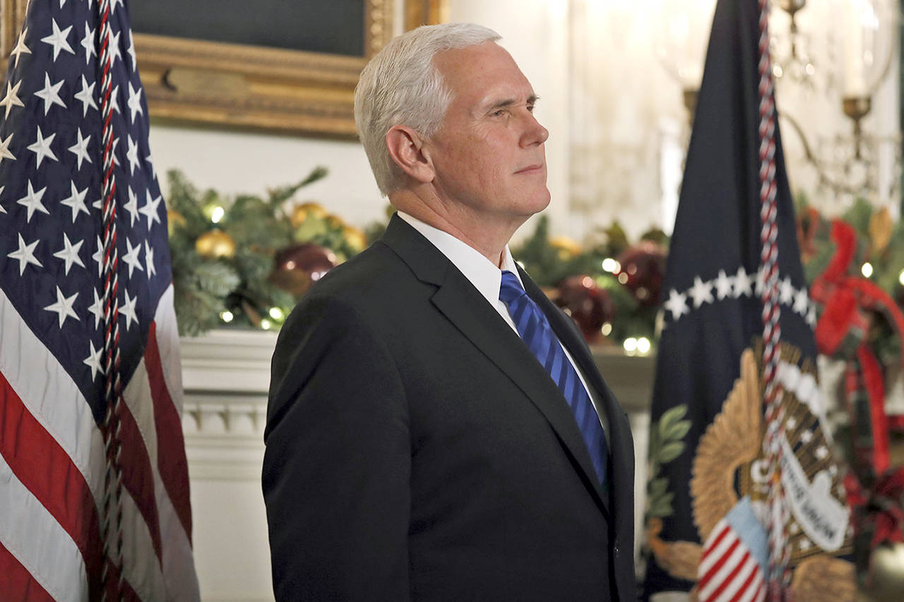 In this Dec. 6 photo, Vice President Mike Pence listens as President Donald Trump speaks in the Diplomatic Reception Room of the White House in Washington. (AP Photo/Alex Brandon, File)