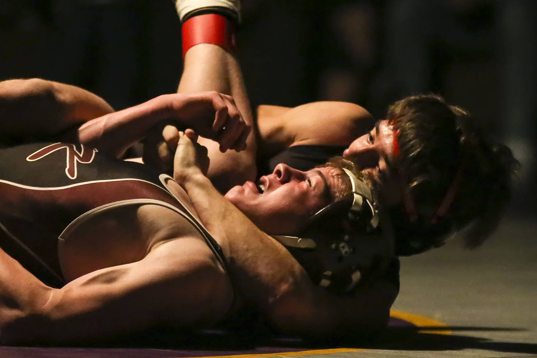 Lake Stevens’ Markus Johnson, right, works to lock Xavier Eaglin of South Kitsap Thursday night at Lake Stevens High School in Lake Stevens on December 21, 2017. (Kevin Clark / The Daily Herald)
