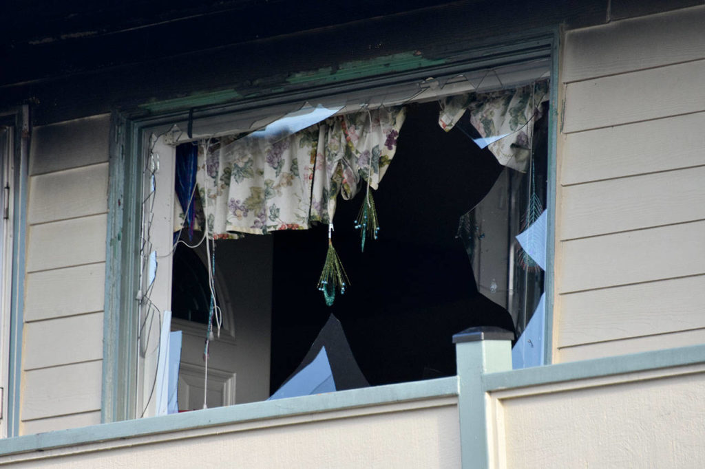 Broken windows and burned walls were the aftermath of a fire that injured two people Thursday night at Colby Square Apartments. (Caleb Hutton / The Herald)
