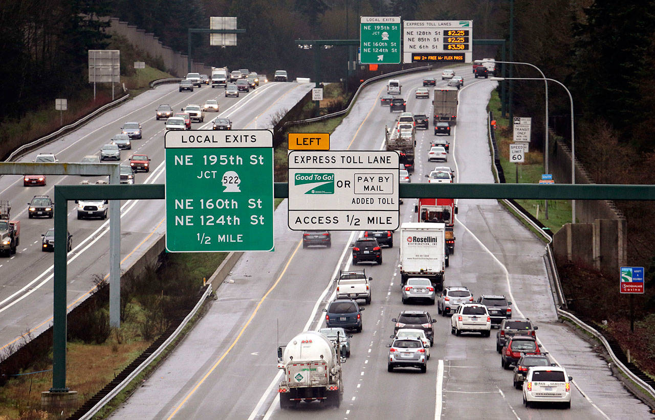 Signs on southbound I-405 give information on the tolls for using express lanes in February, 2016, in Bothell. (Elaine Thompson / Associated Press)