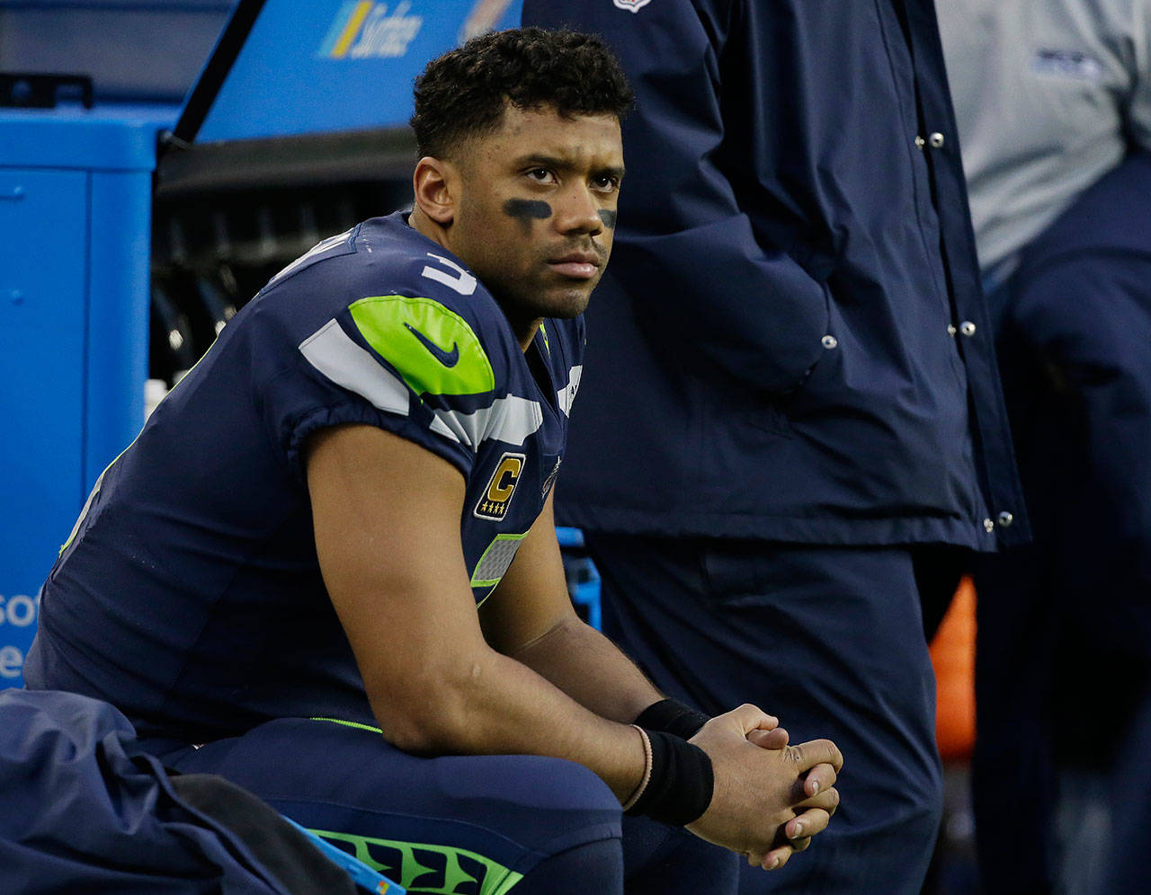 Seahawks quarterback Russell Wilson sits on the bench late in the second half of a game against the Rams on Dec. 17, 2017, in Seattle. (AP Photo/Elaine Thompson)