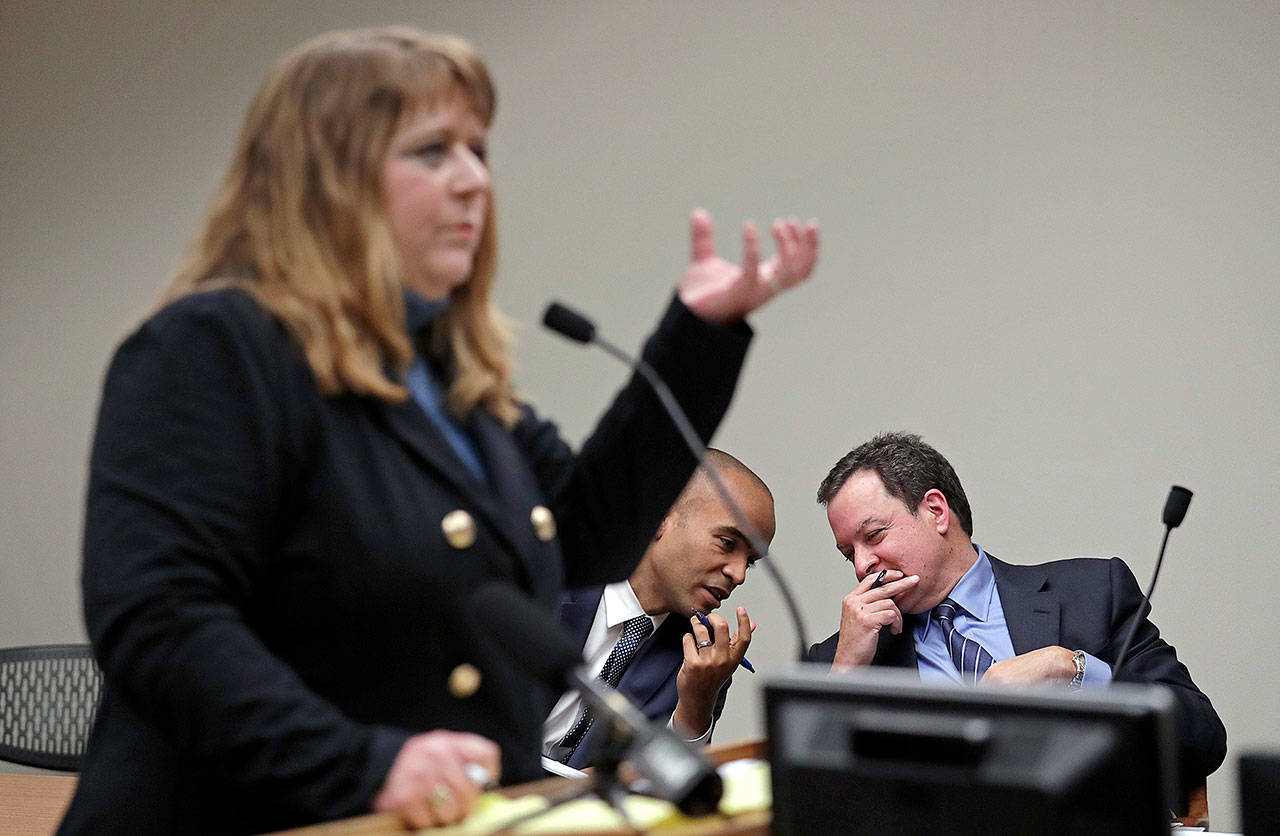 Plaintiff’s attorney Michele Earl-Hubbard (left) addresses Thurston County Superior Court on Friday as defense attorneys Paul Lawrence (right) and Nick Brown confer during a hearing on a lawsuit filed against the Legislature by a coalition of news organizations over records access. (AP Photo/Elaine Thompson)