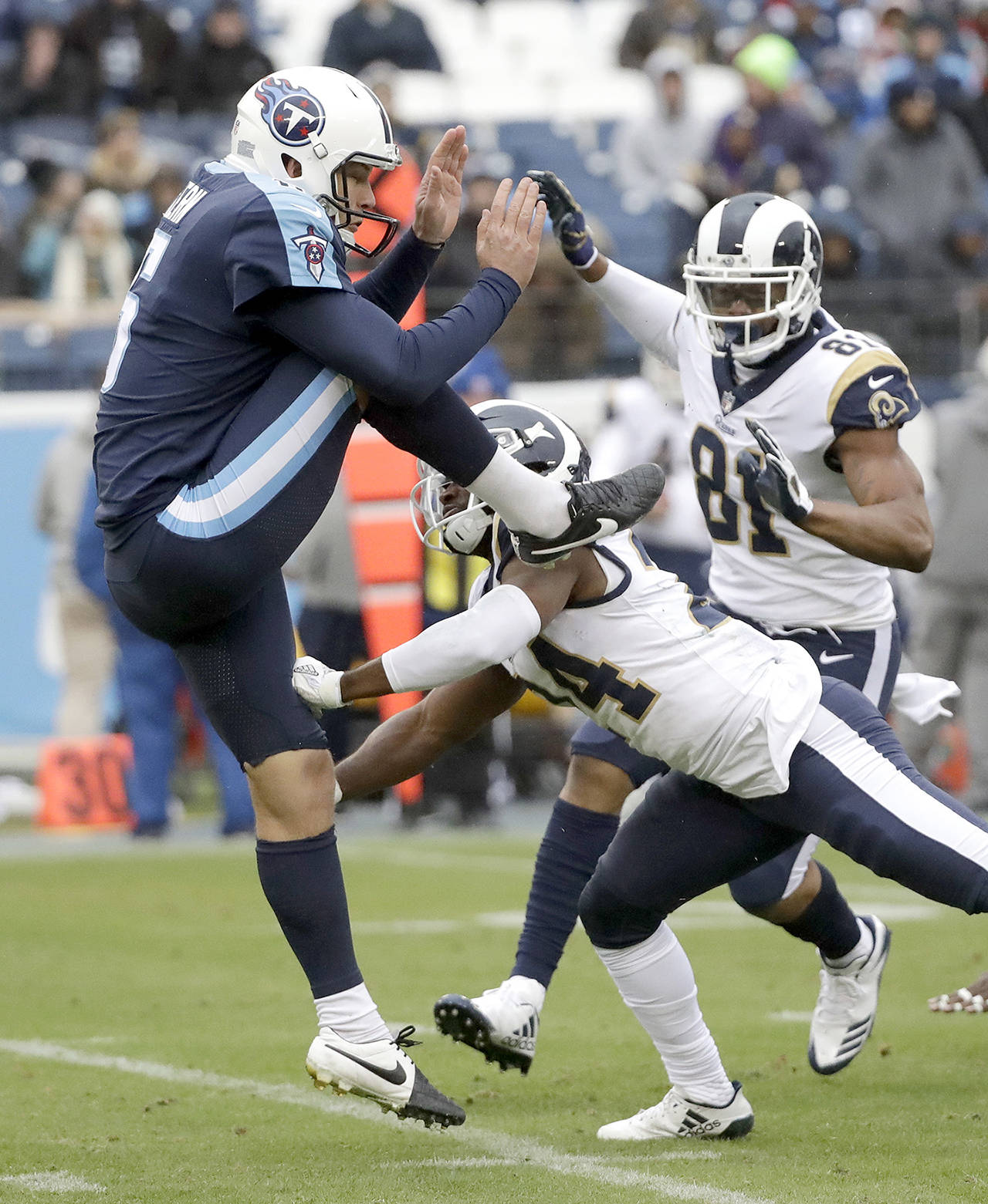 Los Angeles Rams’ Blake Countess (24) pressures Tennessee Titans punter Brett Kern (6) as Rams’ Gerald Everett (81) follows during the second half of an NFL football game Sunday in Nashville, Tennessee. No penalty was called on the play. (AP Photo/James Kenney)