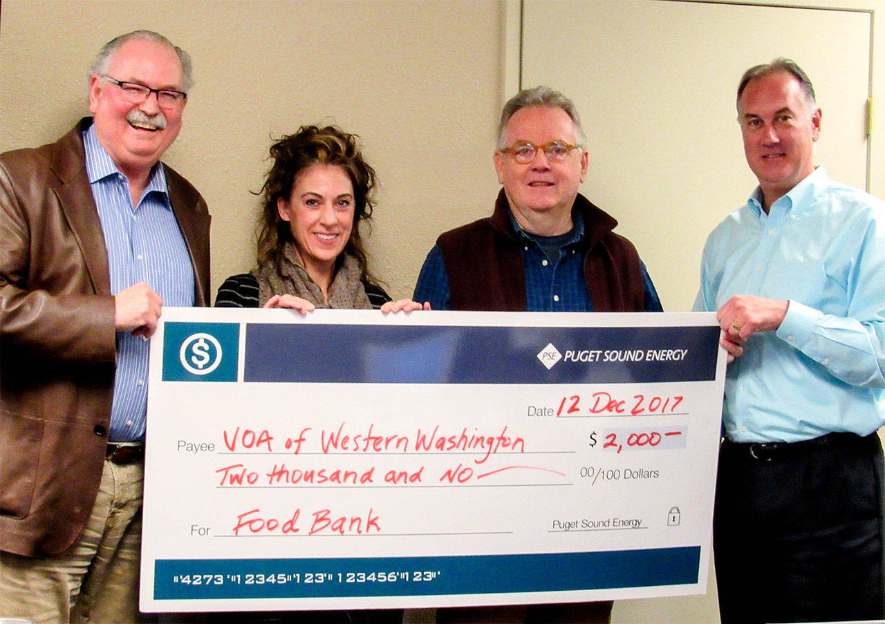 Puget Sound Energy donated $2,000 to benefit Volunteers of America’s Everett Food Bank. Pictured from left are Phil Smith, Alison Cook, Walt Blackford and Bob McMahon. (Contributed photo)