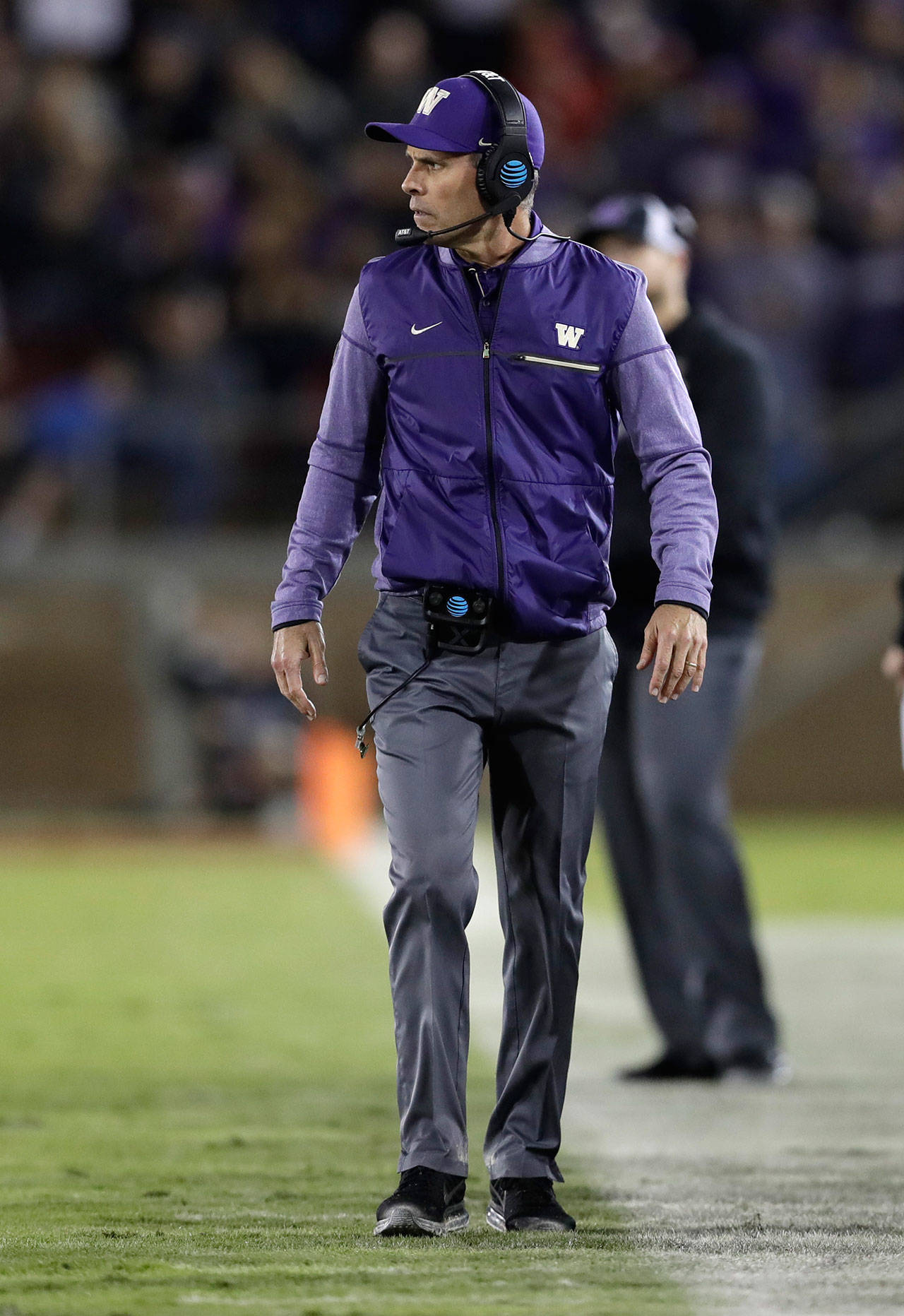 Washington head coach Chris Petersen walks the sideline during the first half of a game against Stanford on Nov. 10 in Stanford, California. (Associated Press/Marcio Jose Sanchez)