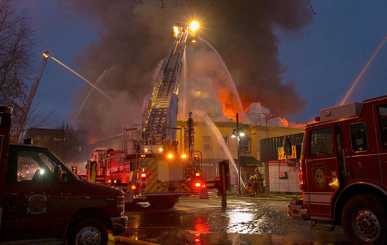 Firefighters at the Heritage Building in Auburn on Tuesday. (Ellen M. Banner/The Seattle Times via AP)