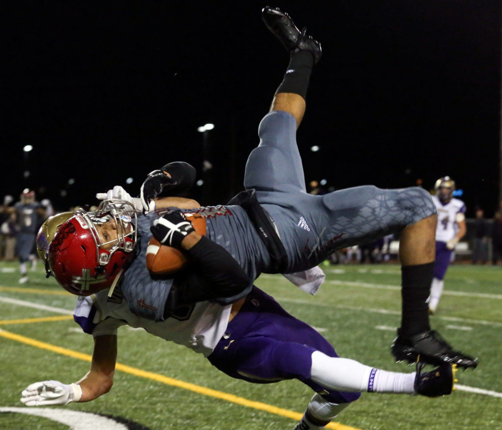 Archbishop Murphy’s Kyler Gordon makes a reception as North Kitsap’s Josh Steakhouse defends at Veterans Memorial Stadium in Snohomish on Nov. 17. (Kevin Clark / The Herald)