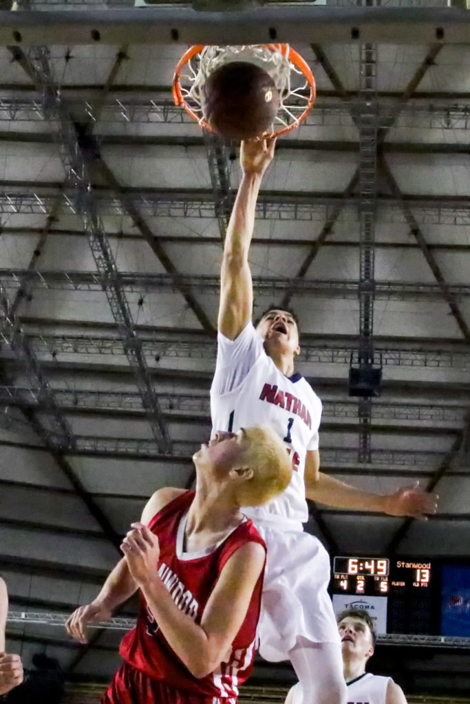 Nathan Hale’s Michael Porter Jr. dunks over Stanwood’s Bryson Kelley during the 3A Hardwood Classic state tournament at the Tacoma Dome on March 2. (Kevin Clark / The Herald)