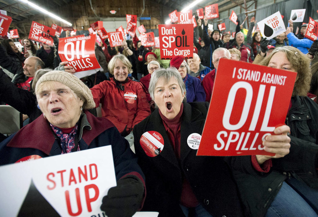 In this Jan. 5, 2016 photo, Maureen Hildreth (center) shouts as she protests with others during a public hearing on a proposed southwest Washington state massive oil-handling facility in Ridgefield, Washington. (Natalie Behring/The Columbian via AP, File)
