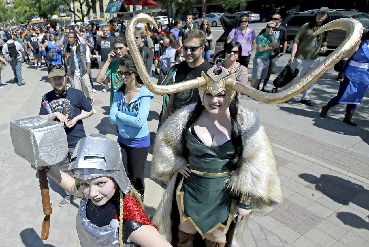 In this Sept. 4 photo, Jessica Nowan (left) and Caitlin Grandstaff (right) stand in line for the Salt Lake Comic Con at the Salt Palace Convention Center, in Salt Lake City. (AP Photo/Rick Bowmer, File)