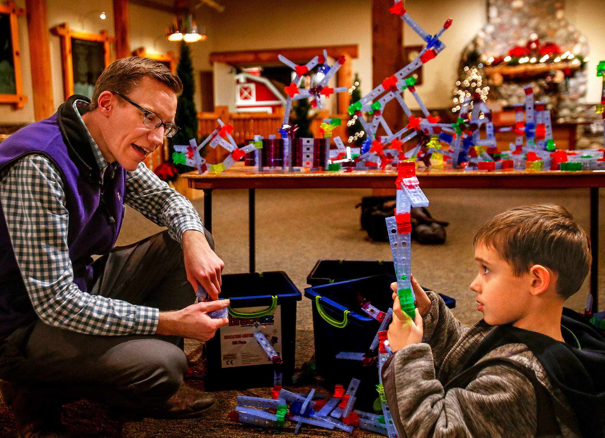 Nick Spicher, program innovation manager at Everett’s Imagine Children’s Museum, talks with Ezra Tamas, 5, on Wednesday. (Dan Bates / The Herald)
