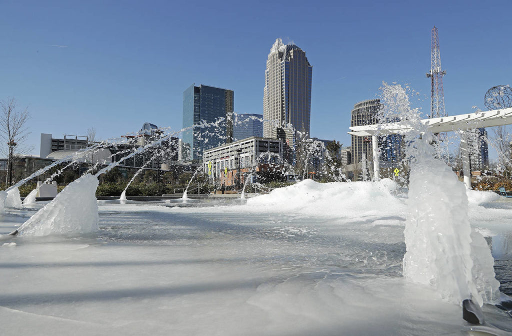 Water squirts from a frozen fountain near downtown in Charlotte, North Carolina, on Tuesday. (AP Photo/Chuck Burton)
