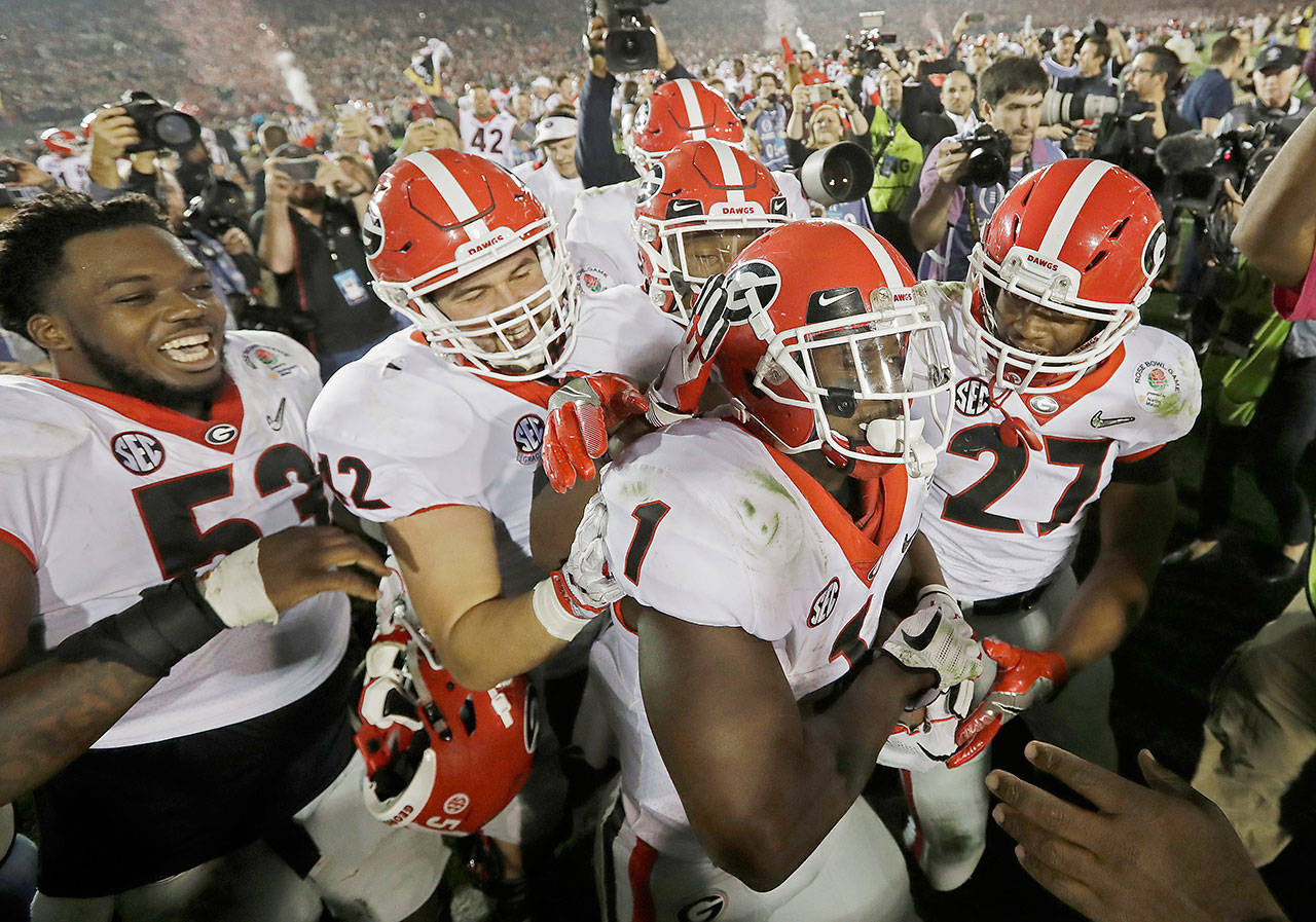 Georgia’s Sony Michel (1) celebrates with teammates after scoring the game-winning touchdown in the second overtime to give Georgia a 54-48 win over Oklahoma in the Rose Bowl on Monday in Pasadena, Calif. Georgia will play Alabama or Clemson for the national championship. (AP Photo/Doug Benc)