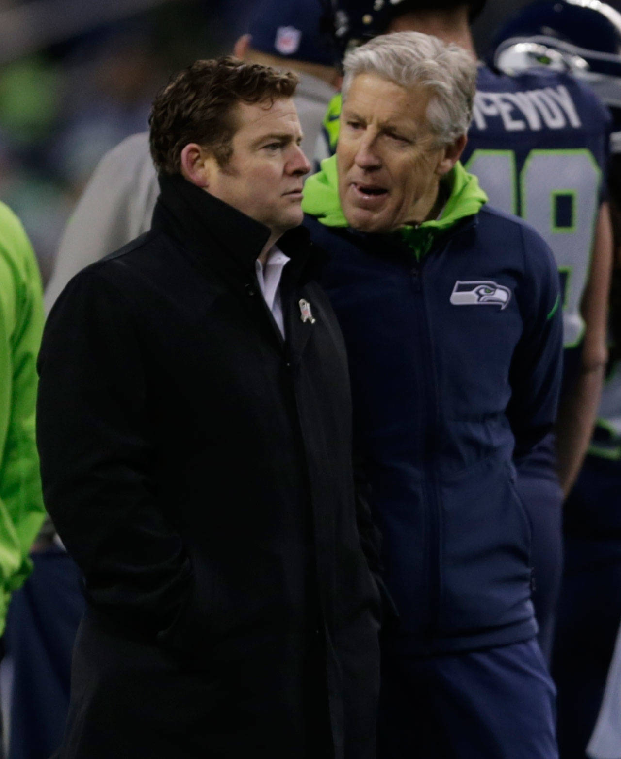 Seahawks general manager John Schneider (left) talks with head coach Pete Carroll before a playoff game against the Lions on Jan. 7, 2017, in Seattle. (AP Photo/Stephen Brashear)