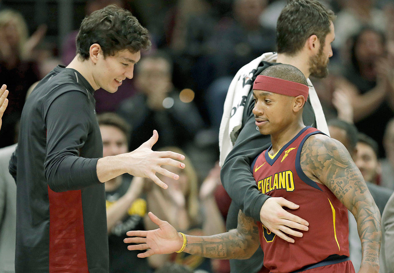 Cleveland’s Isaiah Thomas is congratulated by teammates as he walks to the bench in the second half of the Cavaliers’ 127-110 victory over Portland on Tuesday in Cleveland. (AP Photo/Tony Dejak)