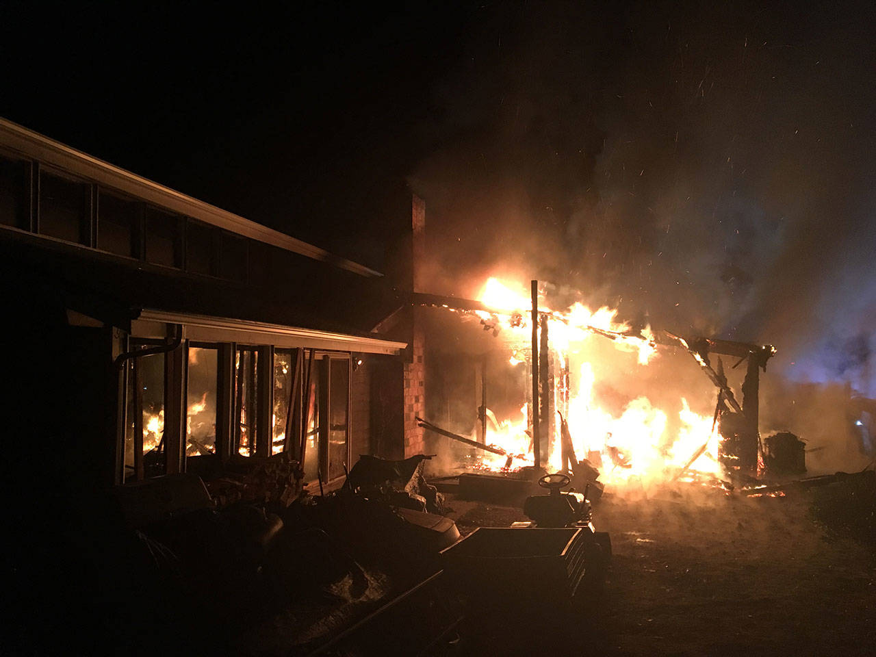 Fire burns a carport attached to a home in Bothell around 4 a.m. Wednesday, Jan. 3. (Snohomish County Fire District 7)