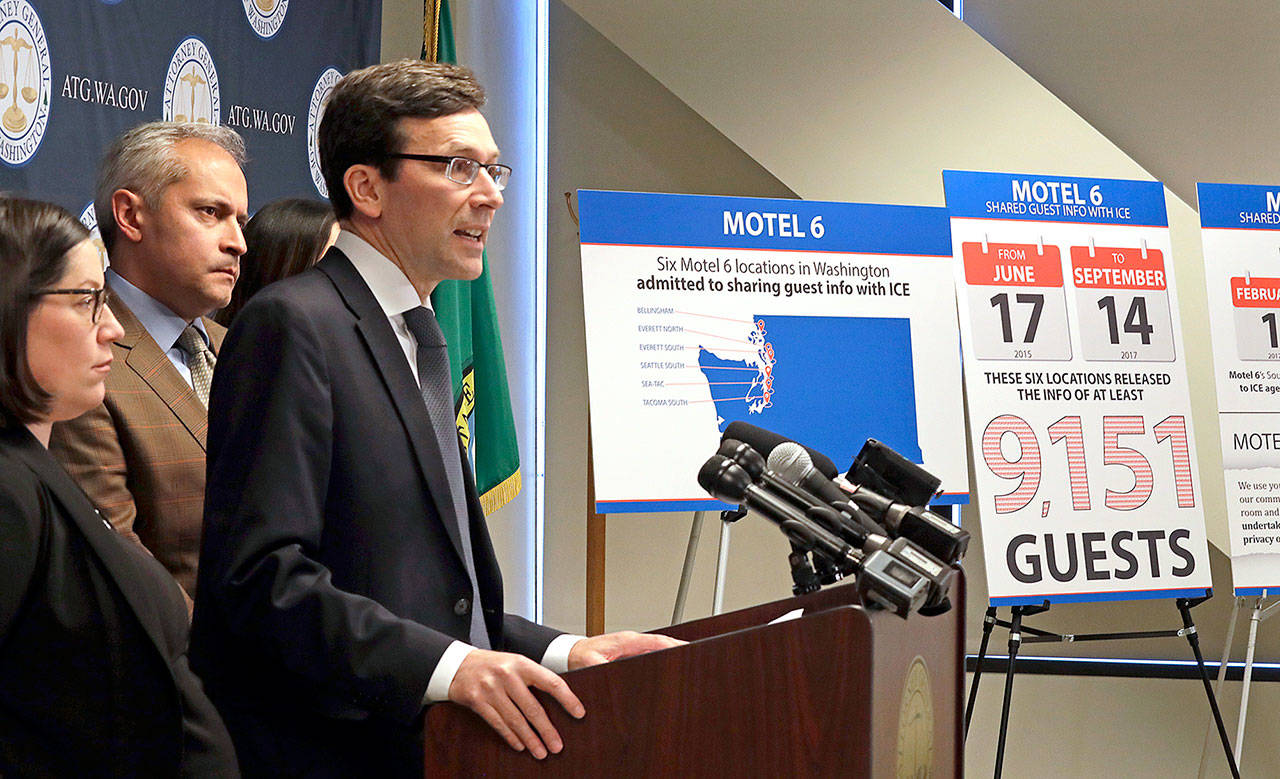Washington state Attorney General Bob Ferguson addresses a news conference Wednesday in Seattle, announcing that his office is suing Motel 6. (AP Photo/Elaine Thompson)