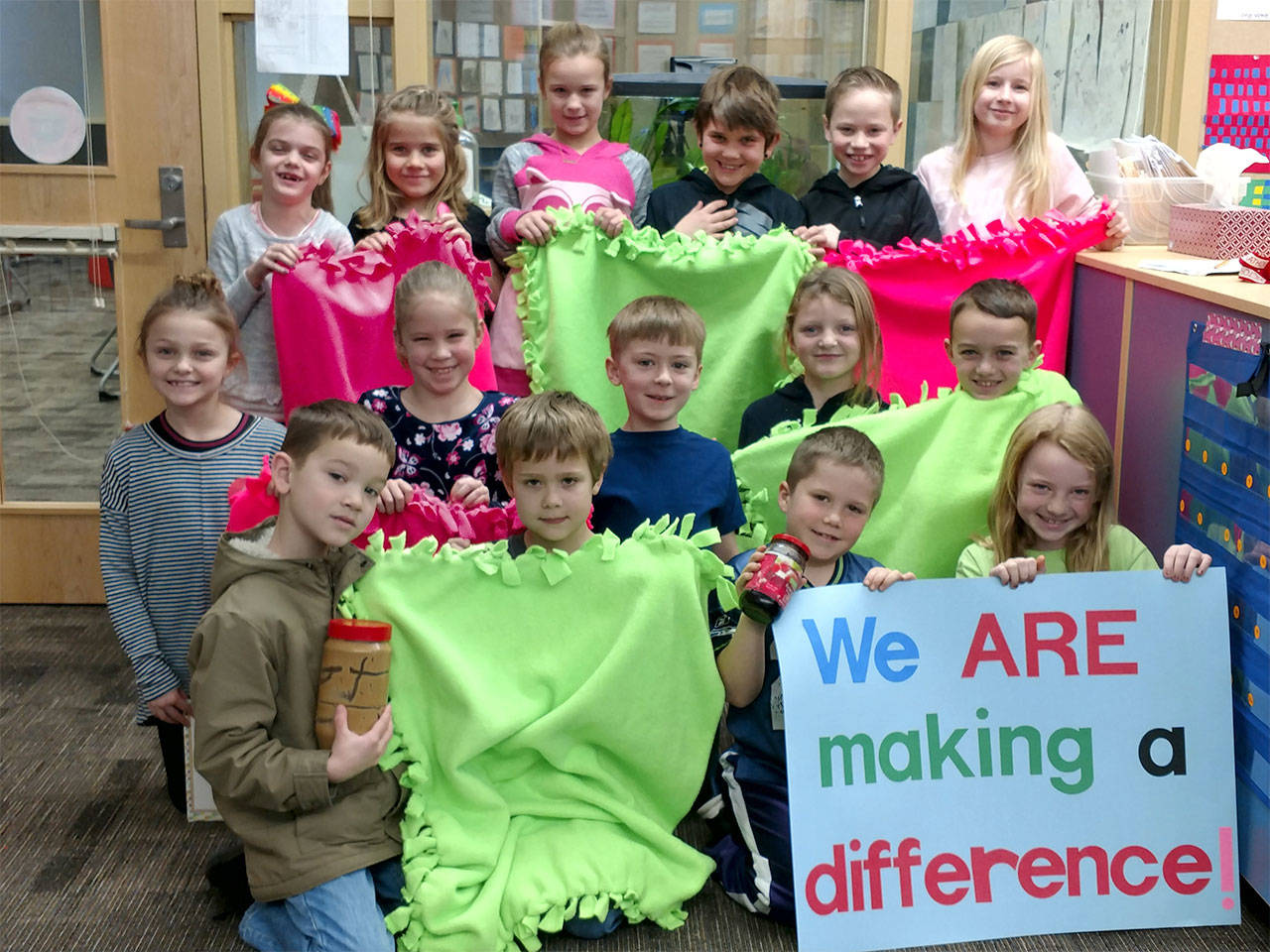 Students in second-grade teacher Stephanie Chlebowski’s class at Machias Elementary School display some of the blankets they made for local hospice patients. The students also make peanut butter and jelly sandwiches for the homeless, among other service projects. (Contributed photo)