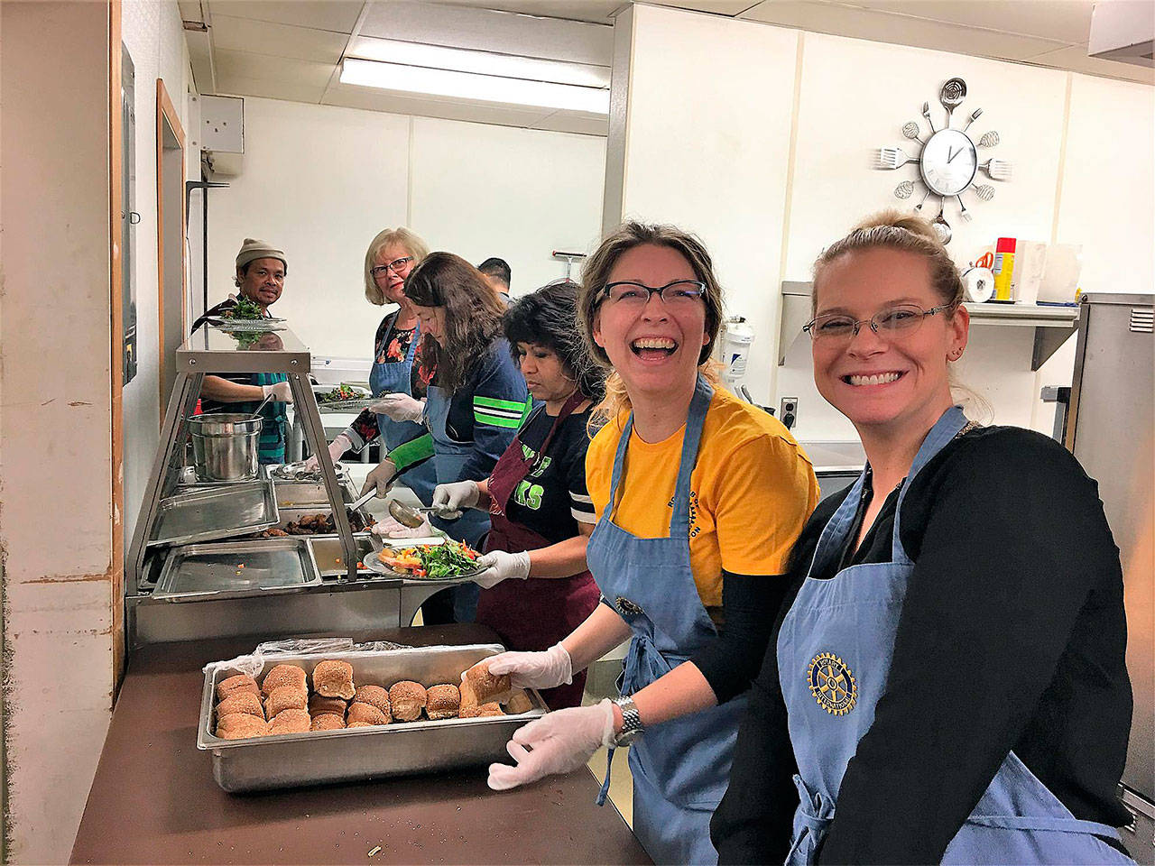 Arlington Rotary volunteers Jessica Martin (left) and Breanne Martin help prep meals in the kitchen at the Stillaguamish Senior Center on Dec. 15. (Contributed photo)