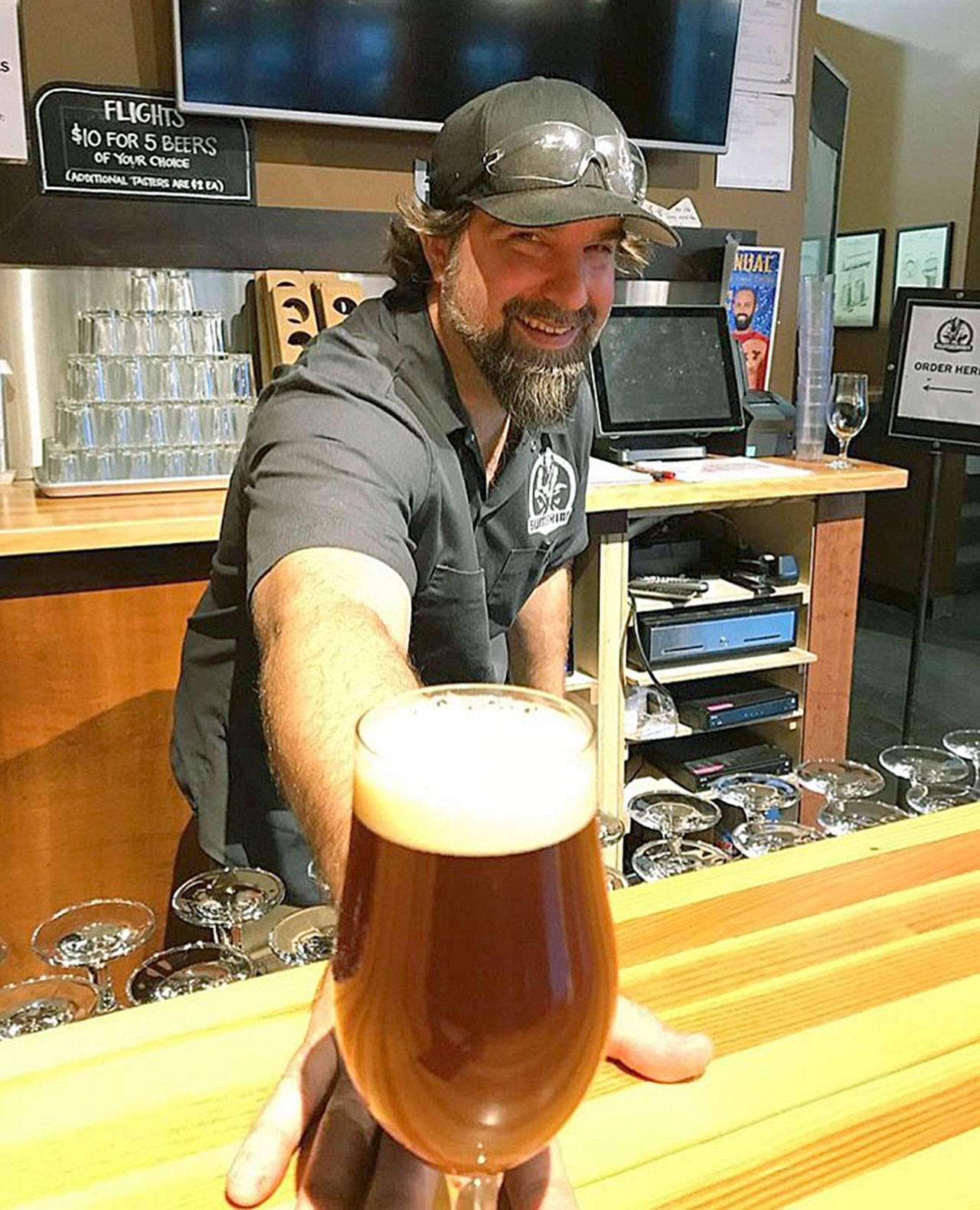 Sumerian Brewing’s Tyson Schiffner offers up one of the brewers newest beers, a Scotch ale. (Sumerian Brewing)