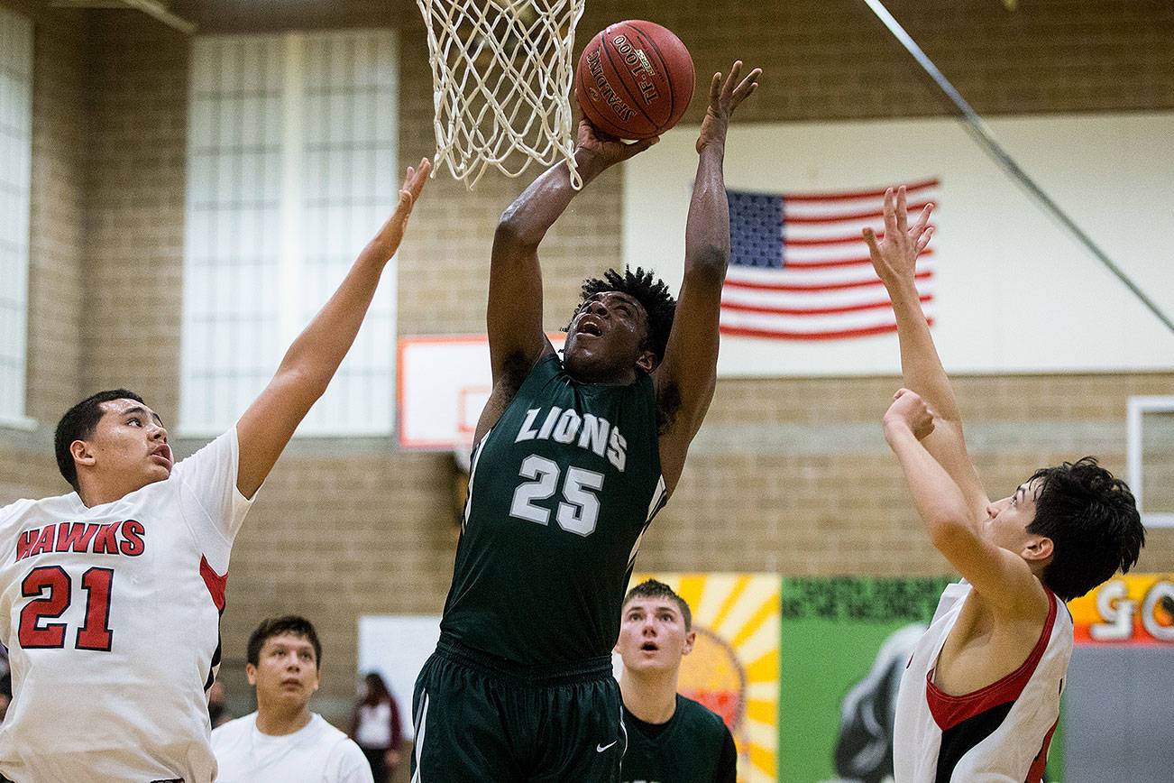 Cedar Park Christian’s Jaide St.Lewis puts up a shot between Tulalip Heritage’s Samuel Fryberg, left, and Isaac Hadley-Comenote as Tulalip Heritage School lost to Cedar Park Christian (Mountlake Terrace) 62-45 on Friday, Jan. 5, 2018 in Tulalip Reservation, Wa. (Andy Bronson / The Herald)