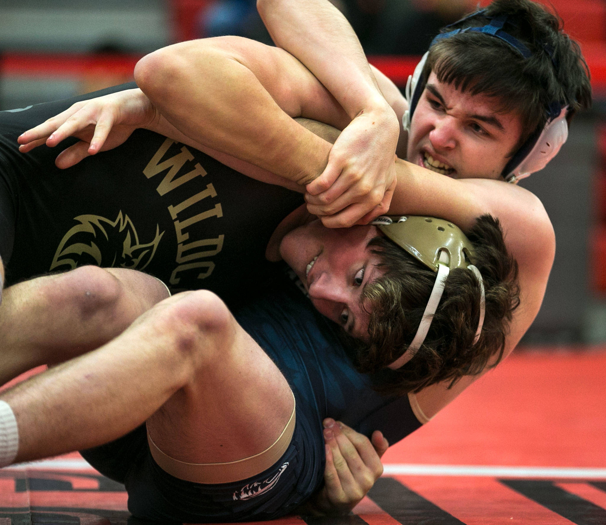 Oak Harbor’s Blake McBride, left, wrestles Arlington’s Gavin Howell during the Panther Classic at Snohomish High School Saturday night in Snohomish on January 6, 2018. McBride won the wt:145 championship. (Kevin Clark / The Daily Herald)                                Oak Harbor’s Blake McBride (left) wrestles Arlington’s Gavin Howell on Saturday during the Panther Classic tournament’s145-pound championship match at Snohomish High School. McBride went on to post an 11-4 win. (Kevin Clark / The Daily Herald)