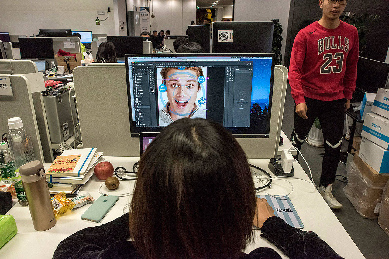 At Megvii offices in Beijing, a designer prepares marketing material for a facial-recognition product. The company’s marketing manager has said Megvii’s Face program has helped police make thousands of arrests. (Photo for The Washington Post by Gilles SabriÈ