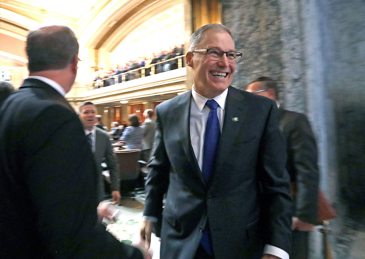 Gov. Jay Inslee leaves the House chamber following his annual state-of-the state address before a joint legislative session Tuesday in Olympia. (Elaine Thompson / Associated Press)
