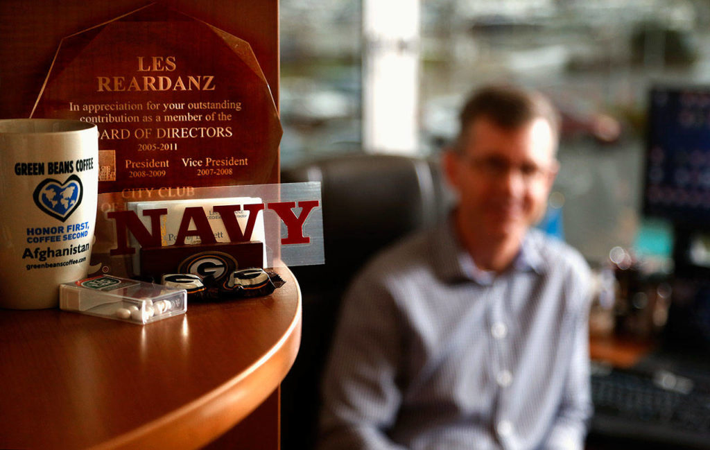 In corners and on shelves in Les Reardanz’s office, the United States Navy maintains a presence. Now, the Port of Everett CEO and naval reservist will spend the better part of a year in Afghanistan. (Dan Bates / The Herald)
