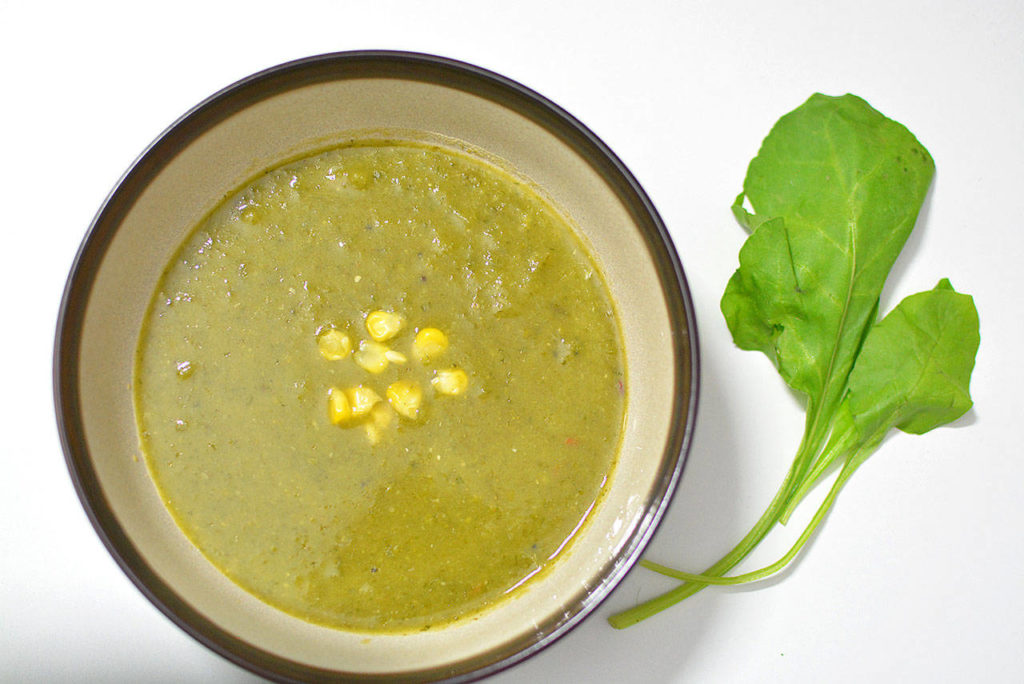 The author likes to garnish this spinach and lentil soup with some cooked corn.
