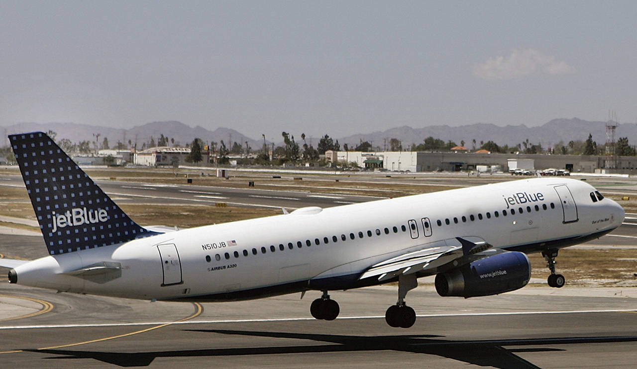 This 2007 photo shows an Airbus A320 JetBlue aircraft in Burbank, California. JetBlue is handing out $1,000 bonuses to its employees. (AP Photo/Damian Dovarganes, File)