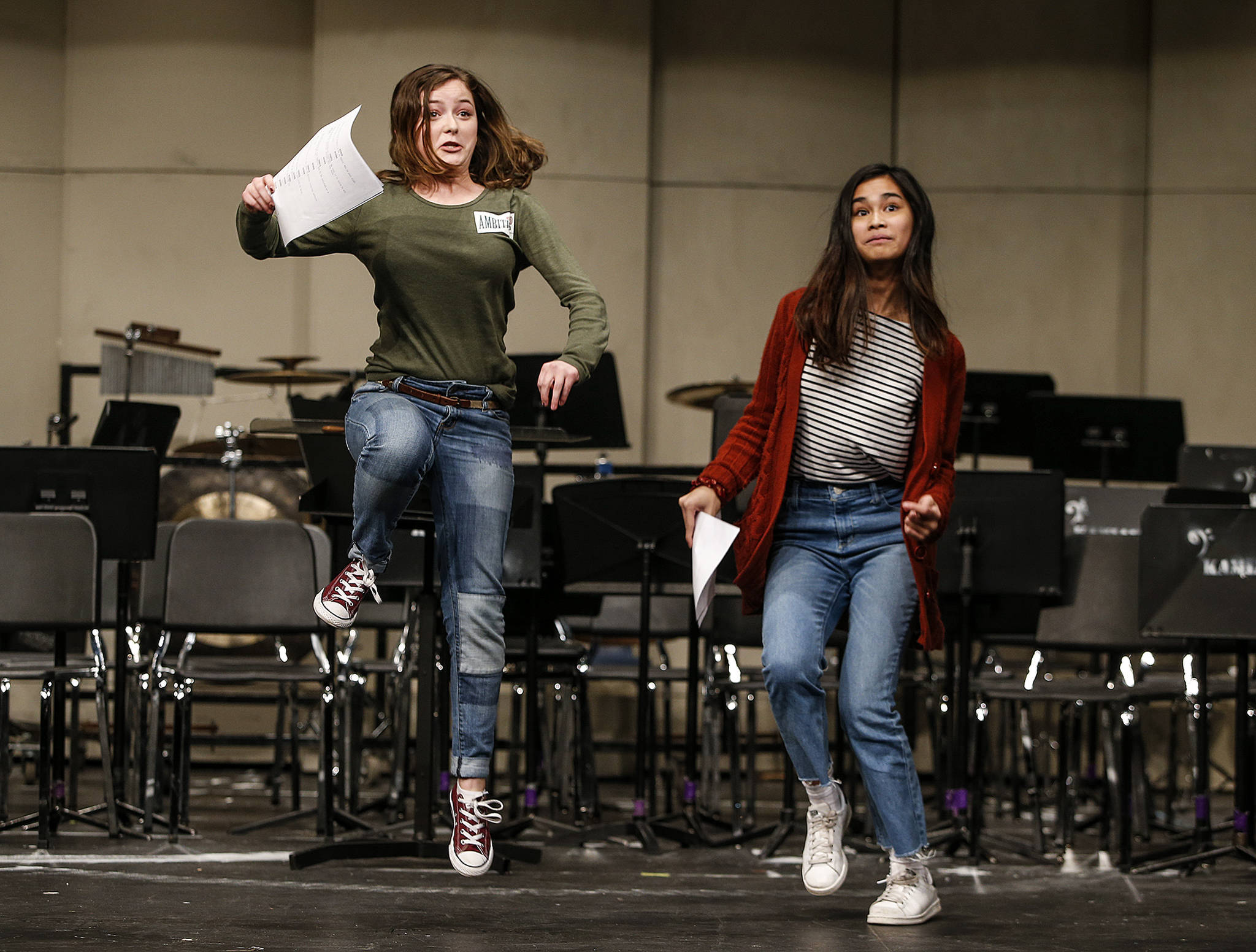 Kamiak students Paige Cox (left) and Lauren Bocalan do their best to enunciate their lines while also pretending to ride a horse during an audition for “Spamalot” at the Mukilteo school. Both were cast. (Ian Terry / The Herald)
