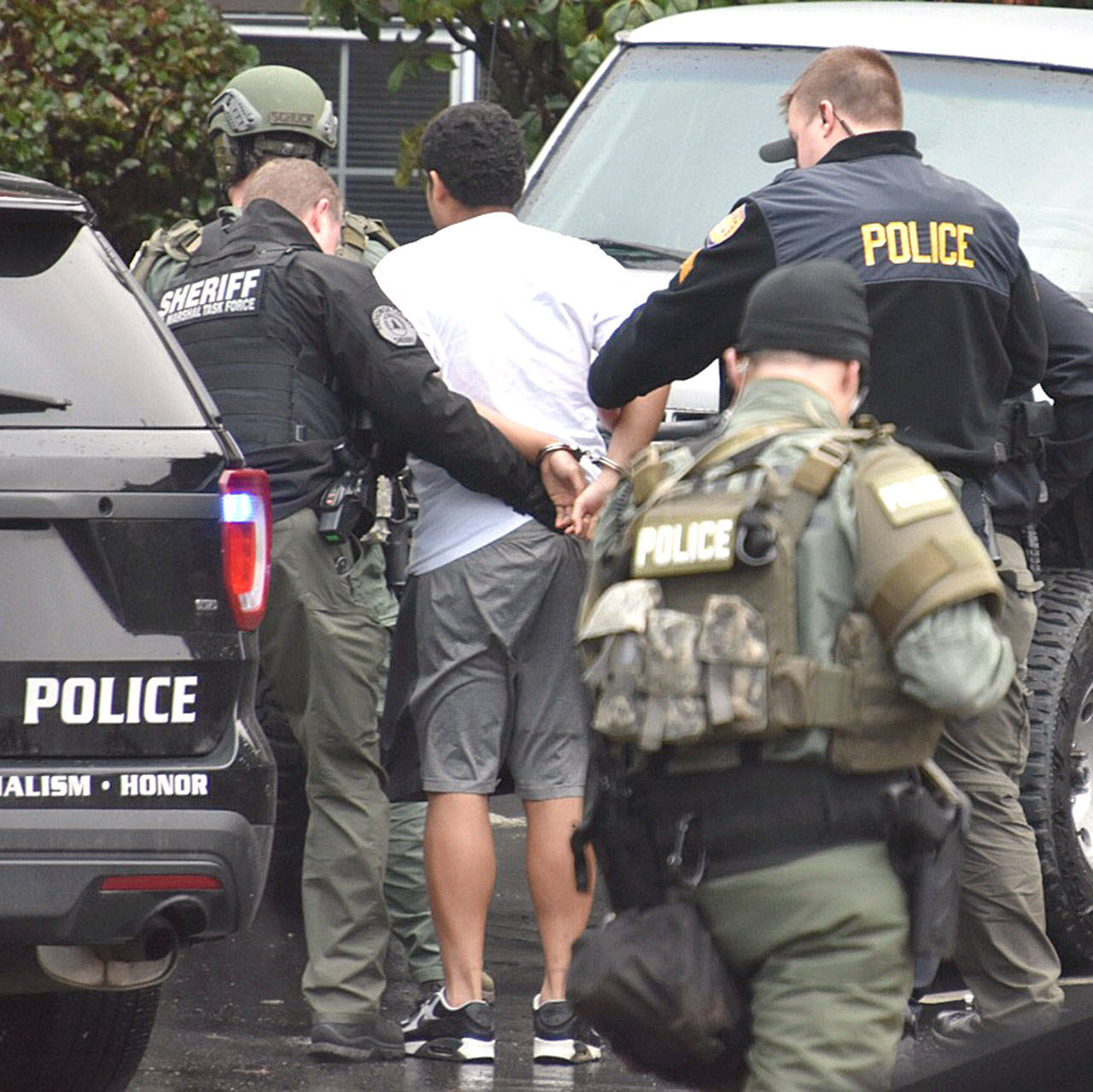 Police arrest a suspect at an apartment building south of Everett on Thursday. (Caleb Hutton / The Herald)