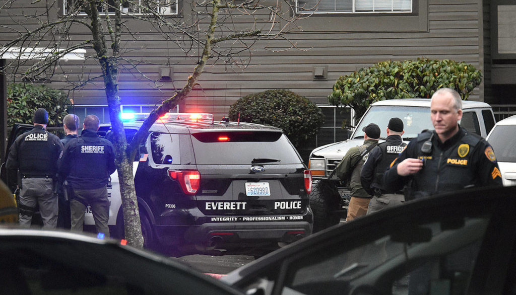 Everett police converged on The Mark apartments on Fourth Avenue W Thursday afternoon. (Caleb Hutton / The Herald)
