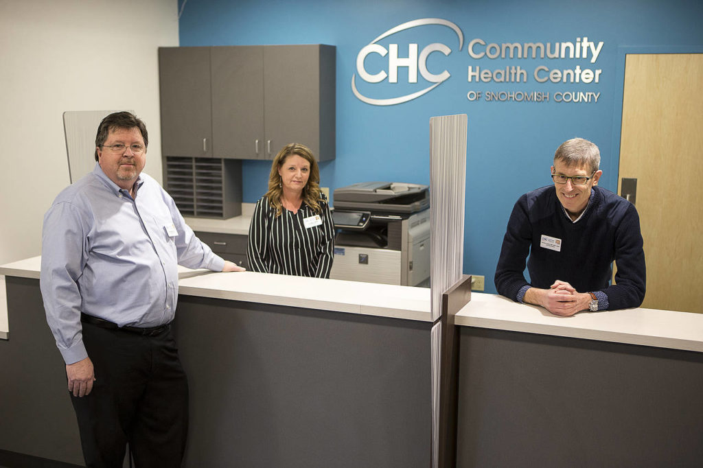 Community Health Center of Snohomish County Chief Executive Officer Bob Farrell (from left), Chief Operating Officer Lisa Miller and Chief Clinical Officer Dr. Thomas Tocher stand in the newest clinic location on Rucker Avenue in Everett. (Ian Terry / The Herald)
