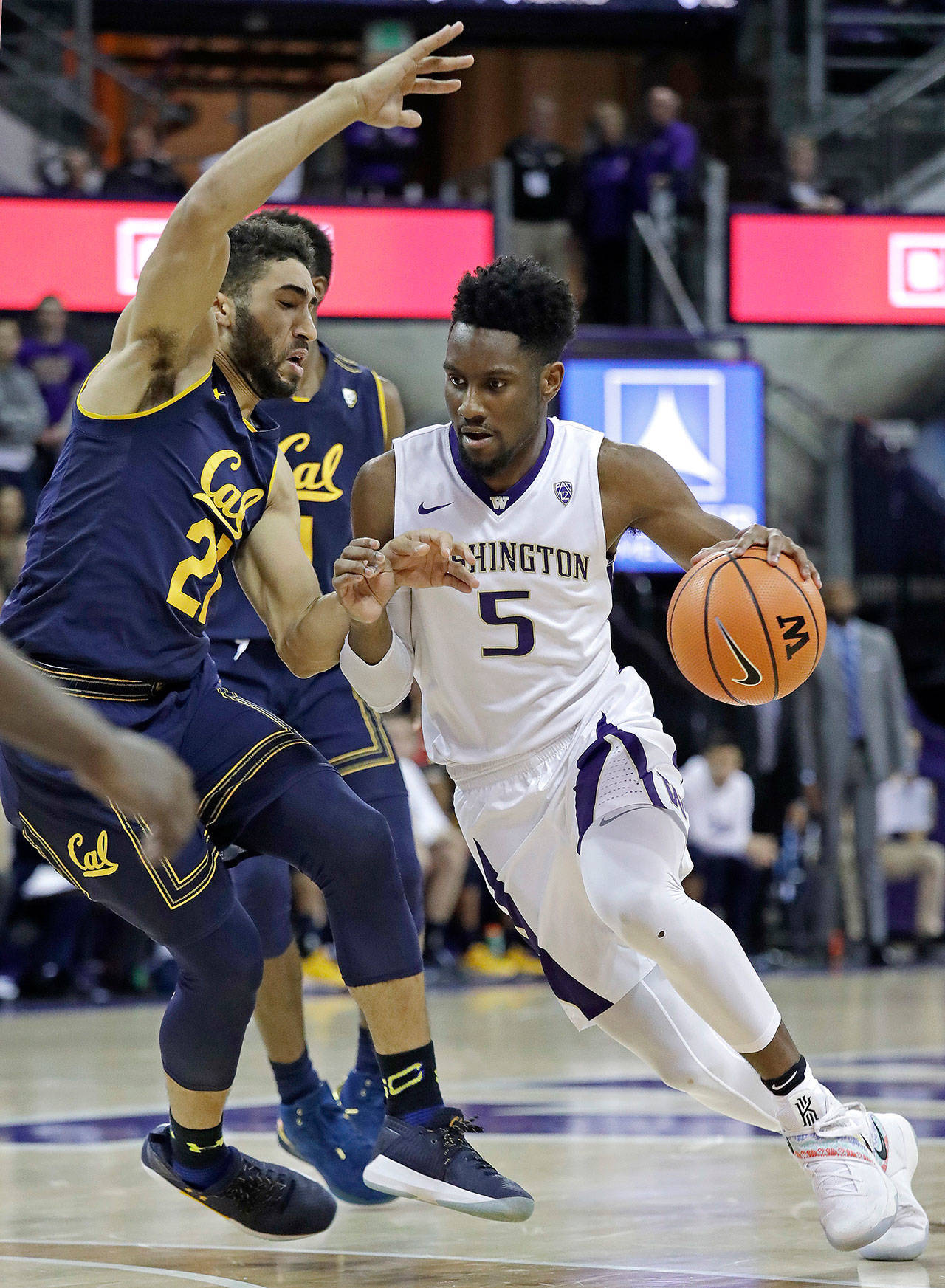 Washington’s Jaylen Nowell (5) drives past California’s Nick Hamilton during the second half of the Huskies’ 66-56 victory over the Golden Bears on Thursday in Seattle. Nowell, a freshman, led UW with 20 points. (AP Photo/Elaine Thompson)