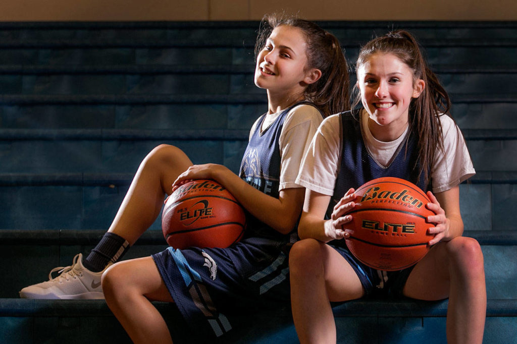 Hayley Kesselring (left) plays on the Meawdowdale girls basketball C-team, while her older sister, Taylor (right), is on the Mavericks’ varsity squad. (Kevin Clark / The Herald)
