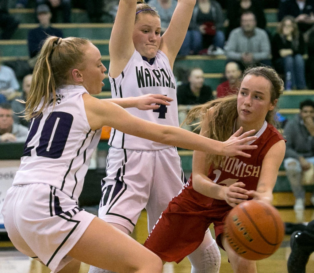 Snohomish’s Maya DuChesne (right) looks to pass with Edmonds-Woodway’s Brooke Kearney (left) AJ Martineau defending during a game Jan. 12, 2018, at Edmonds-Woodway High School. The Panthers won 66-64. (Kevin Clark / The Herald)
