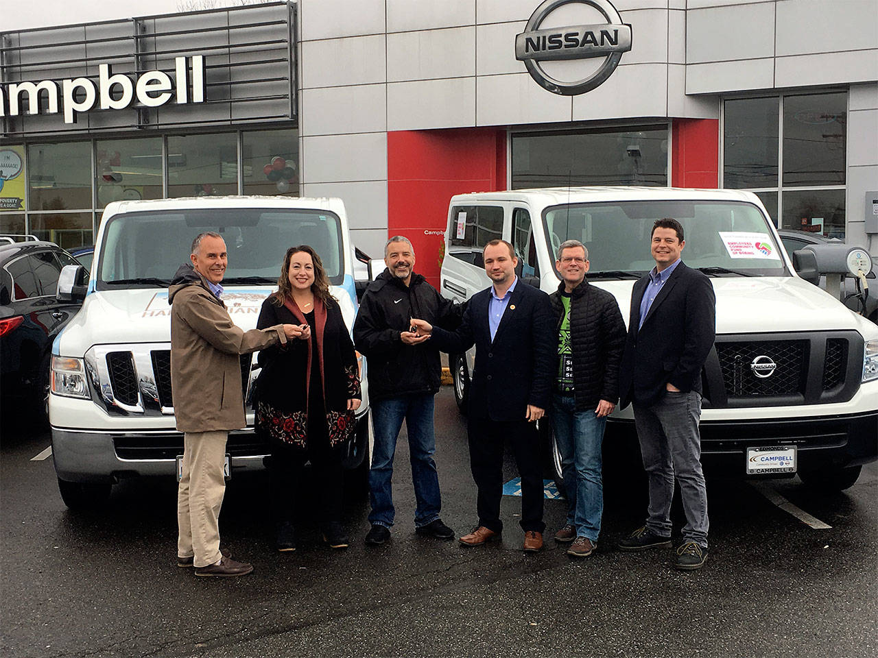 Hand in Hand received a generous donation of two 15 passenger vehicles from Kurt Campbell at Campbell Nissan of Everett and The Employees Community Fund of Boeing Puget Sound. Pictured are Kurt Campbell of Campbell Autogroup, Katie Thielman and Todd McNeal of Hand in Hand, and Robert Malone, Oleg Vakulchik and Kevin Handford, trustees for The Employees Community Fund of Boeing. (Contributed photo)