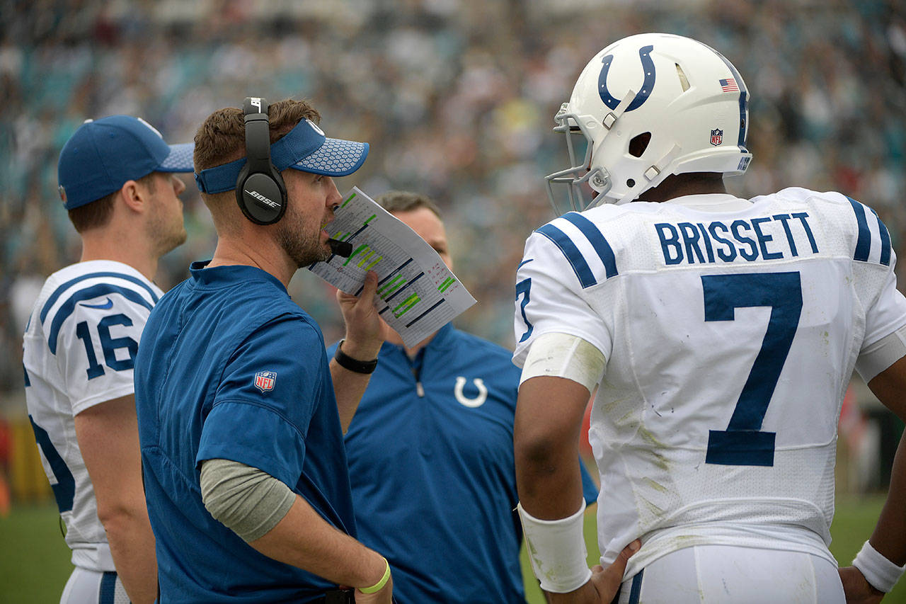 Colts quarterbacks coach Brian Schottenheimer (left) talks with quarterback Jacoby Brissett (7) during the second half of a game against the Jaguars on Dec. 3, 2017, in Jacksonville, Fla. (AP Photo/Phelan M. Ebenhack)