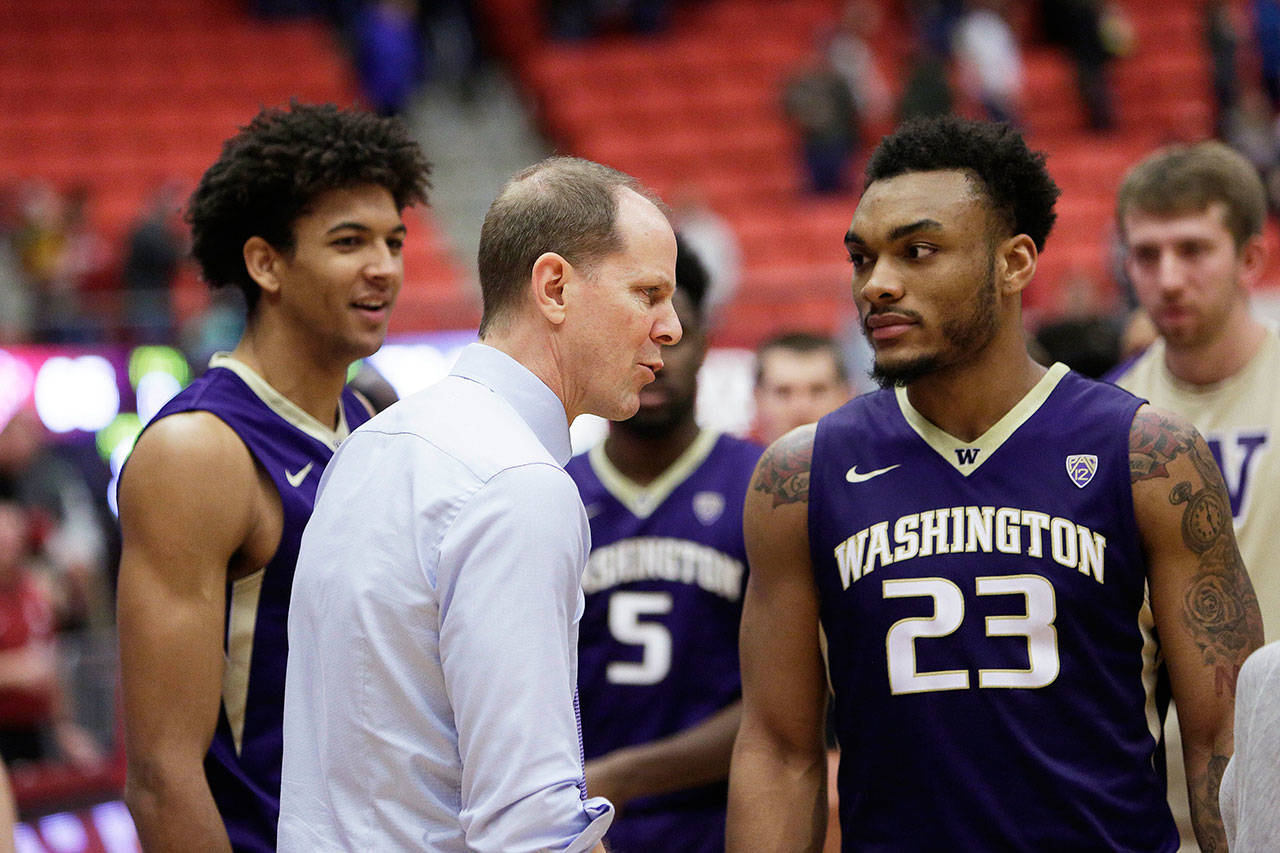 Washington head coach Mike Hopkins (center) speaks with the Huskies’ Carlos Johnson (23) and the rest of the team after a 70-65 win over Washington State on Jan. 6 in Pullman. (AP Photo/Young Kwak)