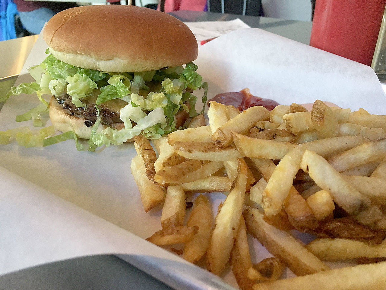 Blu Burgers & Brew in Mukilteo offers a daily lunch special of a classic cheeseburger with a quarter-pound patty, cheddar cheese slice, shredded romaine lettuce, pickle, tomato and house sauce, a side order of fries and a drink for $8.50. (Ben Watanabe / The Herald)