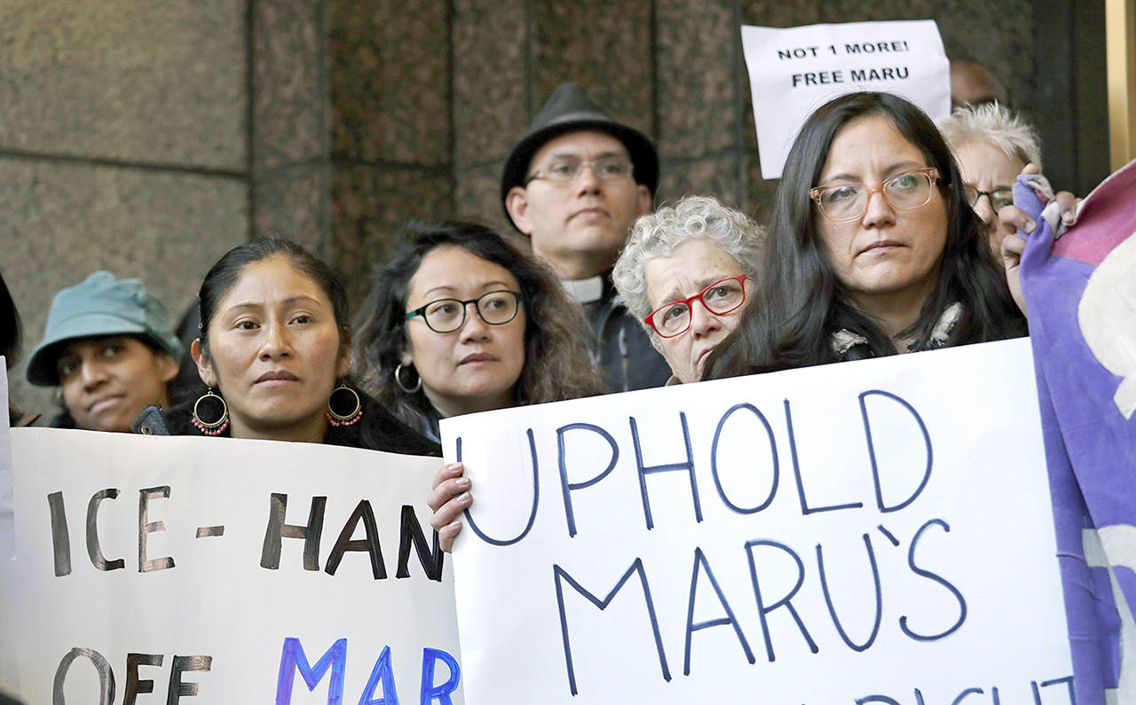Supporters of Maru Mora-Villalpando look on during a Seattle news conference on Tuesday, where the longtime activist for illegal immigrants in the Northwest announced she herself is now facing deportation. (AP Photo/Elaine Thompson)