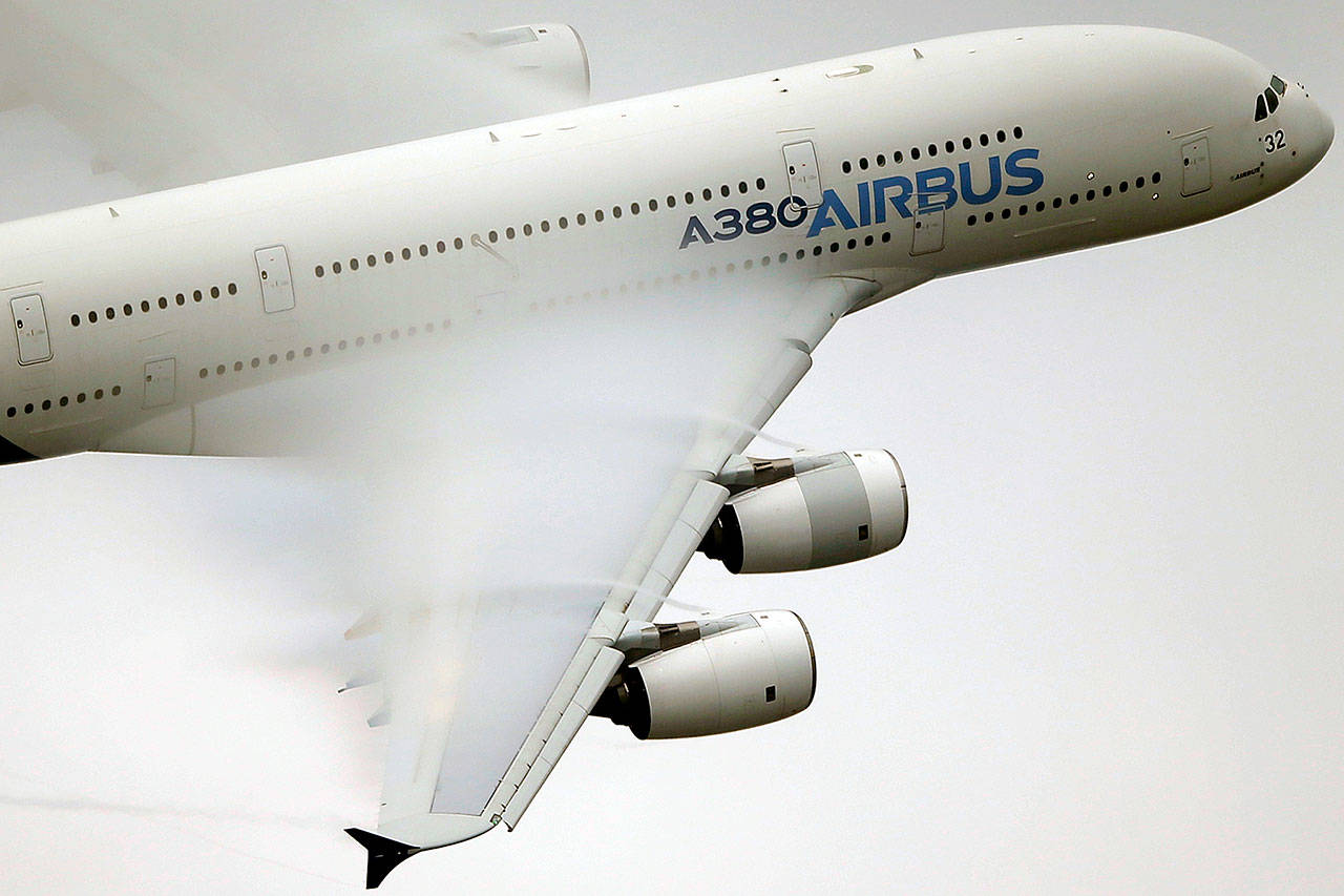 Vapor passes over the wings of an Airbus A380 as it performs a demonstration flight at the Paris Air Show in 2015. (AP Photo/Francois Mori, File)
